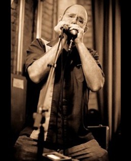 Michael Rubin performing on harmonica