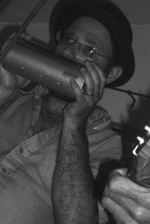 Michael playing the bass harmonica with a microphone